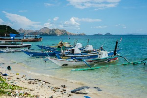 Fishing boats tied up with Komodo in the distance.